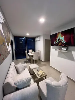 a living room with two couches and a tv at Exclusivo apartamento art zona norte in Cartagena de Indias