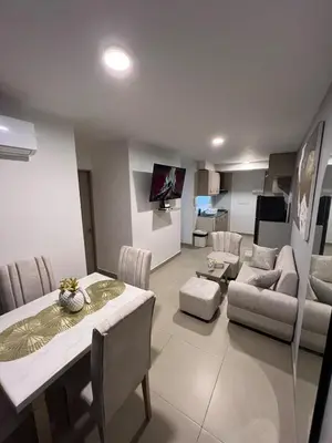 a living room with a table and a dining room at Exclusivo apartamento art zona norte in Cartagena de Indias