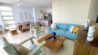 a living room with a blue couch and a table at Magico Apartamento Frente al Mar 3 Habitaciones TR52 in Coveñitas