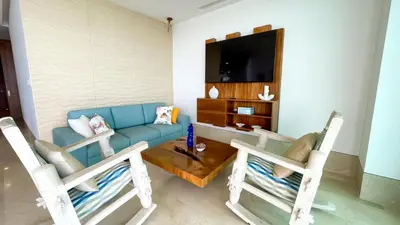 a living room with two chairs and a blue couch at Magico Apartamento Frente al Mar 3 Habitaciones TR52 in Coveñitas