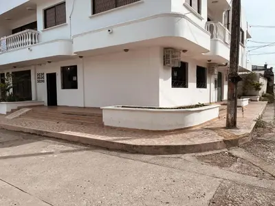 a white building with a boat on the sidewalk at Madili del Mar II in Santiago