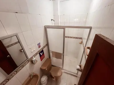 a small bathroom with a toilet and a shower at Madili del Mar II in Santiago