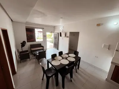 a kitchen and dining room with a table and chairs at Madili del Mar II in Santiago