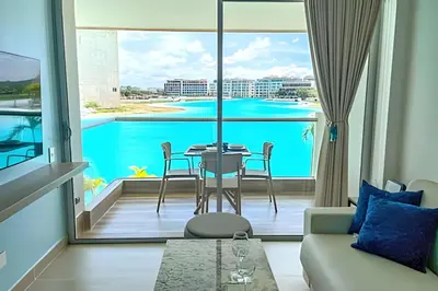 a living room with a view of a pool at 1 Alcoba Hermosa vista a la laguna + bote inflable in Los Arrayanes