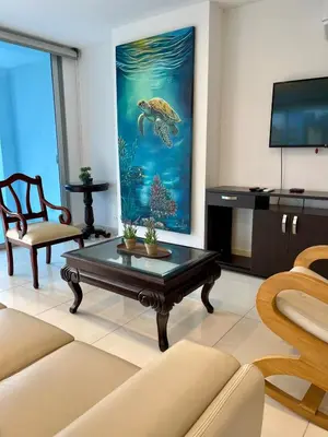 a living room with a turtle painting on the wall at Lujo y espacio Bello Horozonte gran apartamento hasta 10 personas in Santa Marta