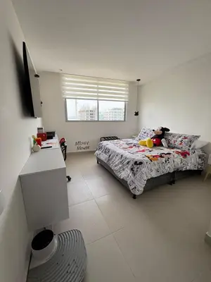 a bedroom with a bed and a television in it at Exclusive apartment with ocean view in Cartagena de Indias
