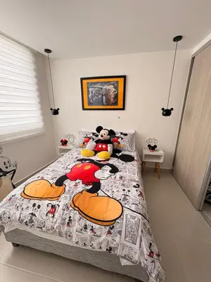 a bedroom with a mickey mouse quilt on a bed at Exclusive apartment with ocean view in Cartagena de Indias