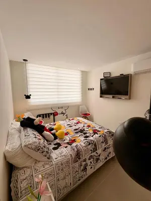 a bedroom with a bed with a comforter on it at Exclusive apartment with ocean view in Cartagena de Indias