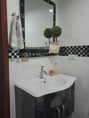 a bathroom with a white sink and a mirror at Hermosa Cabaña C15, Castillo Club in Coveñas
