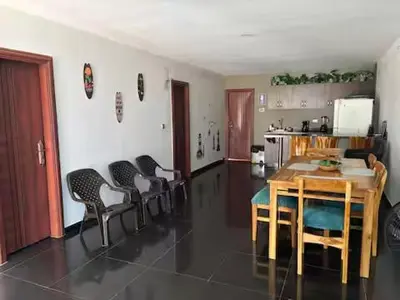 a kitchen with a table and chairs in a room at Hermosa Cabaña C15, Castillo Club in Coveñas
