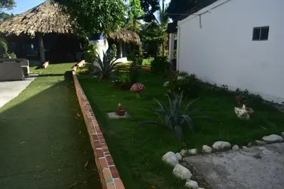 a yard with some animals in the grass at Hermosa Cabaña C15, Castillo Club in Coveñas
