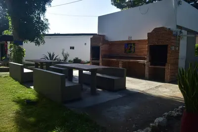 a picnic table and benches in a yard at Hermosa Cabaña C15, Castillo Club in Coveñas