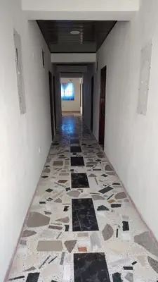a hallway with a tile floor in a building at CARTAGENA BOQUILLA BEACH HOSTEl in Cartagena de Indias