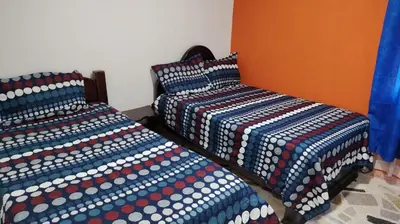 two beds sitting next to each other in a room at CARTAGENA BOQUILLA BEACH HOSTEl in Cartagena de Indias