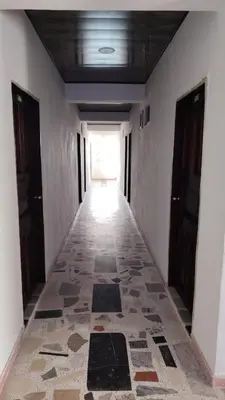 a hallway with a tile floor in a building at CARTAGENA BOQUILLA BEACH HOSTEl in Cartagena de Indias