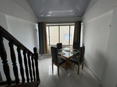 a dining room with a table and chairs and a window at Edificio frente a la playa en cartagena, marbella in Cartagena de Indias