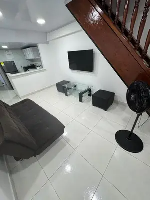 a living room with a couch and a tv at Edificio frente a la playa en cartagena, marbella in Cartagena de Indias