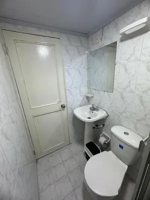 a white bathroom with a toilet and a sink at Edificio frente a la playa en cartagena, marbella in Cartagena de Indias