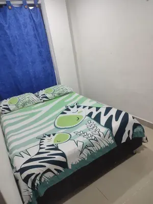 a bedroom with a bed with zebra print sheets at Torices casa hostal 47 in Cartagena de Indias