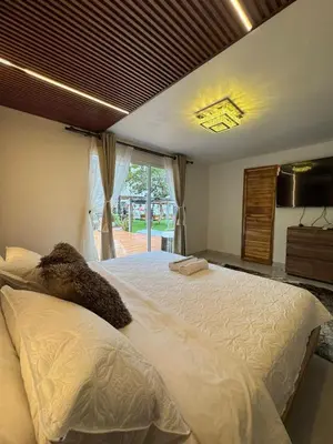 a bedroom with a large bed and a window at Hospedaje de lujo baru in Playa Blanca
