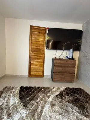 a bedroom with a wooden door and a dresser at Hospedaje de lujo baru in Playa Blanca