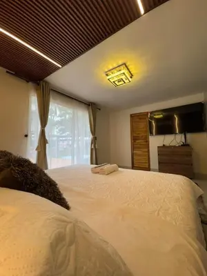 a bedroom with a large white bed with a window at Hospedaje de lujo baru in Playa Blanca