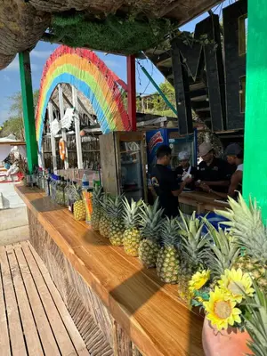 a bar with a rainbow and a bunch of pineapples at Habitaciones luxury baru in Playa Blanca