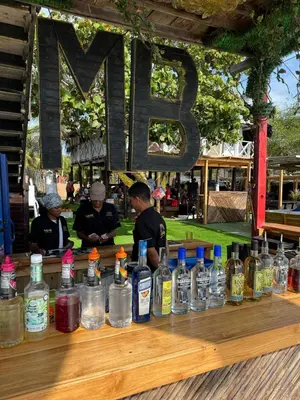 a display of bottles of alcohol on a wooden table at Habitaciones luxury baru in Playa Blanca