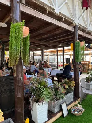 a group of people sitting at a restaurant with plants at Habitaciones luxury baru in Playa Blanca