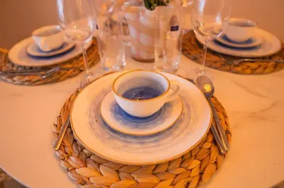 a table with a cup of coffee on a plate at Disfruta el espectáculo de la bahía in Cartagena de Indias