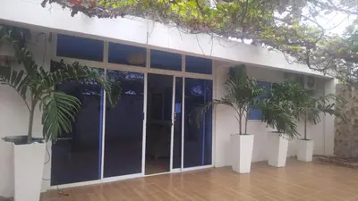 a building with two palm trees in front of it at Hotel Nativo Manzanillo in Cartagena de Indias