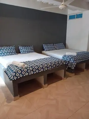 two beds sitting next to each other in a room at Hotel Nativo Manzanillo in Cartagena de Indias