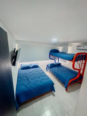 a room with two bunk beds and blue sheets at Apartamento Laguito Cartagena in Cartagena de Indias