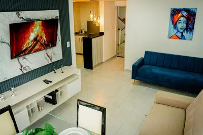 a living room with a blue couch and a tv at Apartamento Laguito Cartagena in Cartagena de Indias