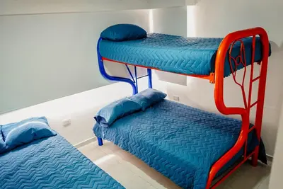 two bunk beds and a bed in a room at Apartamento Laguito Cartagena in Cartagena de Indias