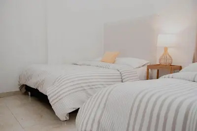 a bedroom with two beds with striped sheets at Comfortable apartment in the historic center in Cartagena de Indias