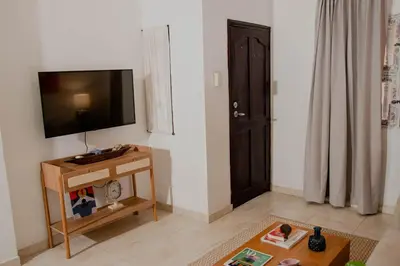 a living room with a flat screen tv on a wall at Comfortable apartment in the historic center in Cartagena de Indias