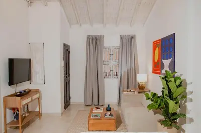 a living room with a tv and a table at Comfortable apartment in the historic center in Cartagena de Indias