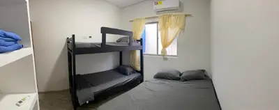 a room with two bunk beds and a window at Apartamento M&M in Coveñas