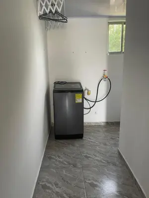 a small refrigerator in a corner of a room at Apartamento M&M in Coveñas