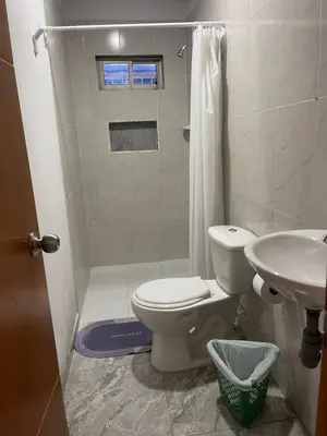 a bathroom with a toilet and a shower and a sink at Apartamento M&M in Coveñas