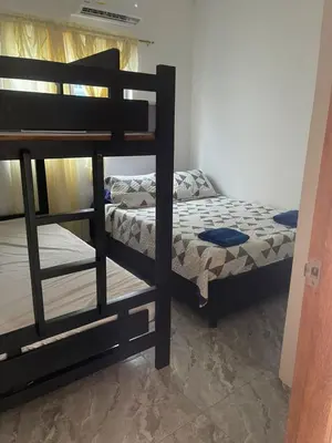 a bedroom with two bunk beds in a room at Apartamento M&M in Coveñas
