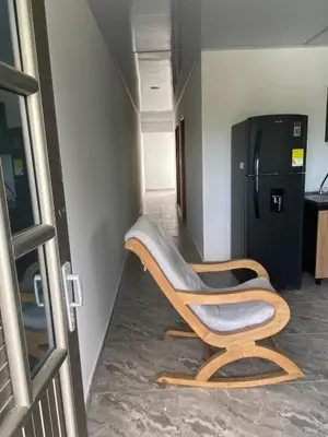 a chair sitting in a hallway next to a refrigerator at Apartamento M&M in Coveñas