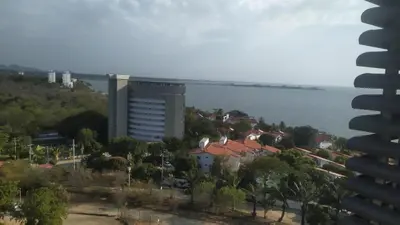 a view of a building with trees and a city at Estrene en Santa Marta vía Barranquilla a 10 minutos aeropuerto, acceso y vista al mar in Santa Marta