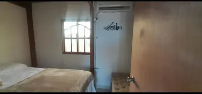 a room with a bed and a door with a window at Cabaña Barbacoas in Santa Ana