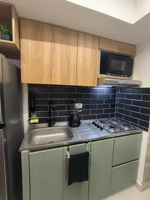 a small kitchen with a sink and a microwave at Apartamento Luxury en Cartagena con Vista al mar in Cartagena de Indias