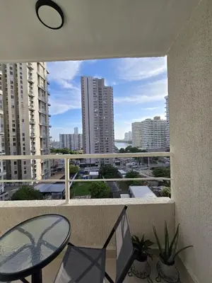 a balcony with a table and chairs and a view of a city at Apartamento Luxury en Cartagena con Vista al mar in Cartagena de Indias