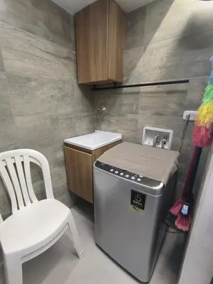 a small kitchen with a stove and a white chair at Apartamento Luxury en Cartagena con Vista al mar in Cartagena de Indias