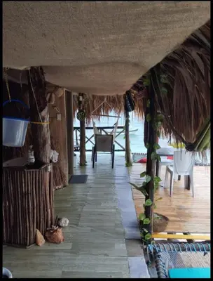 a hallway of a house with a table and chairs at Hostal Ananda in Playa Blanca