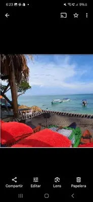 a poster of a beach with a view of the ocean at Hostal Ananda in Playa Blanca
